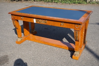 An Empire style gilt metal mounted bird's eye maple bureau plat fitted three drawers, width 160cm, depth 89cm, height 77cm